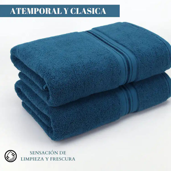 Set de 4 toallas azul profundo de algodón de 130 g, ideales para hotel y spa, con textura suave y absorbente.
