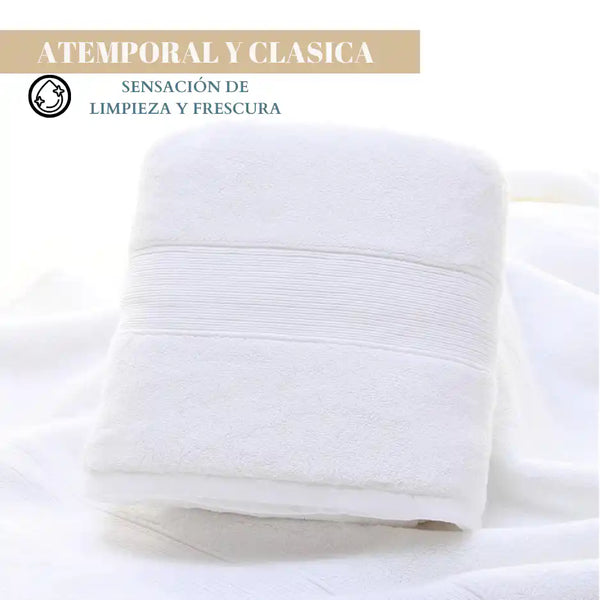 Juego de 4 toallas blancas de algodón de 130 g, ideales para spa y hotel, con textura suave y absorbente.