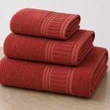 Set de toallas de baño premium de 100% algodón, 3 piezas, con textura suave y absorbente, en tonos blancos y grises.